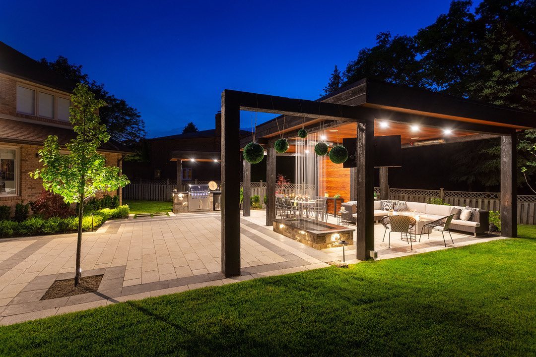 Illuminated pavilion and stone patio