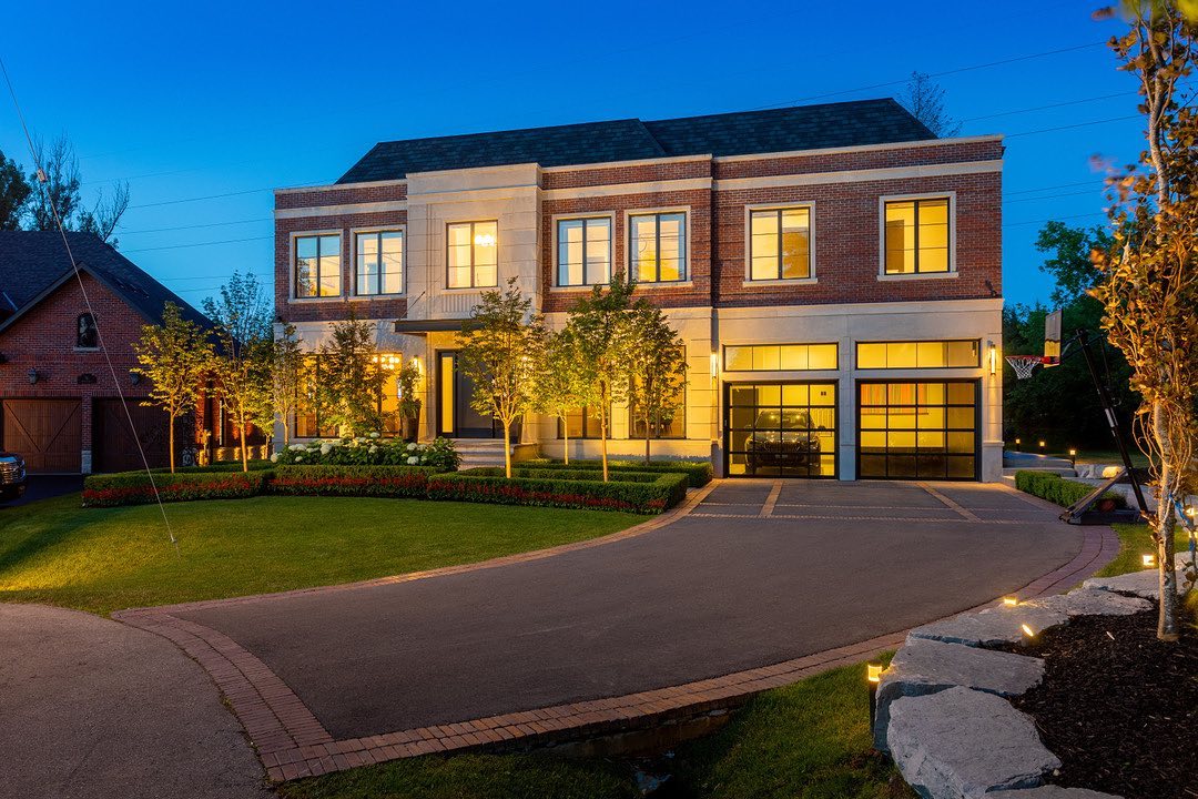 Brick and stone home with landscaped front drive